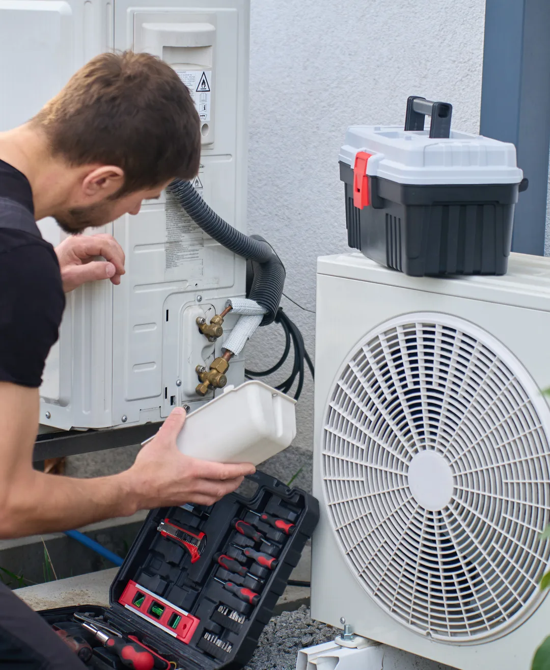 Plain View Solutions technician servicing an outdoor HVAC unit