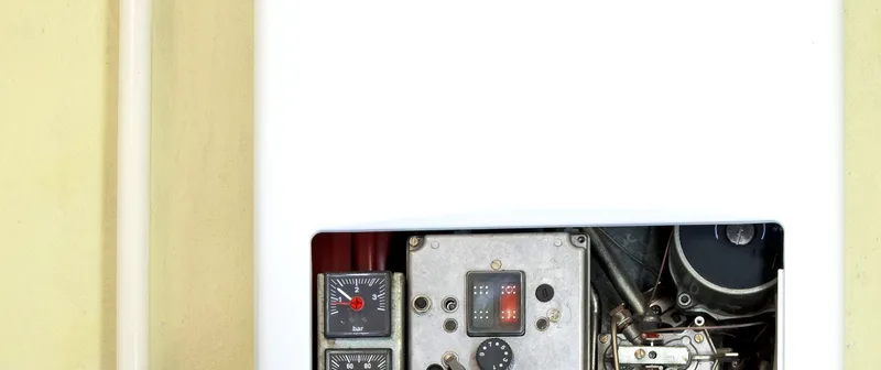 Wall-mounted tankless water heater serviced by Plain View Solutions